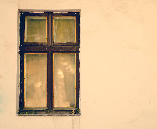 istock Old wooden windows frame on cement cracked wall 494037574