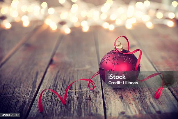 Christmas Ornament Baubles On Old Wood Background With Defocused Lights Stock Photo - Download Image Now