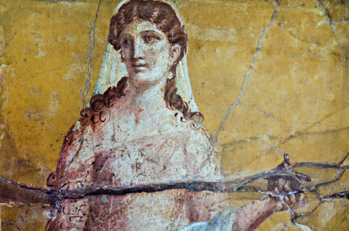 detail of the fresco in Pompeii with winged griffin on a red background Pompeian
