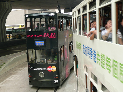 Hong Kong, China - September 13, 2009: colourful iconic double decker electric trams crowded with passengers run in Hong Kong. 