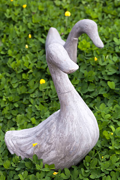 istock stone duck garden decoration 494042067