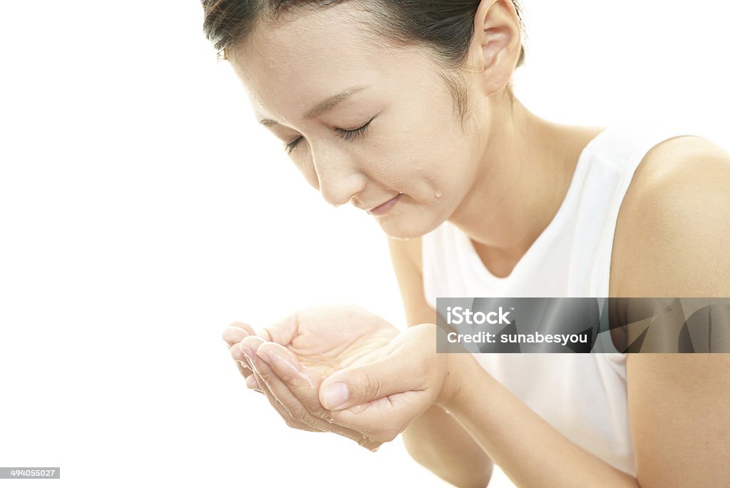 Woman washing her face Woman washing her face isolated on white background Adult Stock Photo