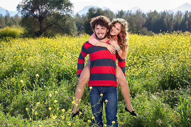 istock Young man giving his girlfriend a piggy back. 494055323