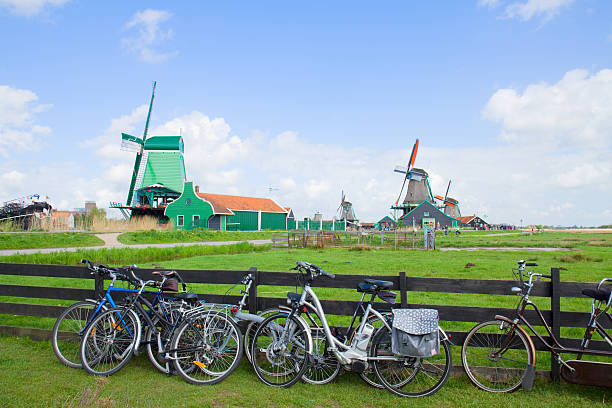 dutch windmills with bikes in Zaanse Schans dutch windmills with bikes  in Zaanse Schans, Holland zaanse schans stock pictures, royalty-free photos & images