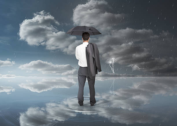 istock Businessman holding a black umbrella 494057257