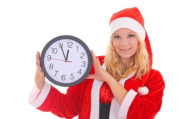 istock girl with santa hat holding clock 494057842