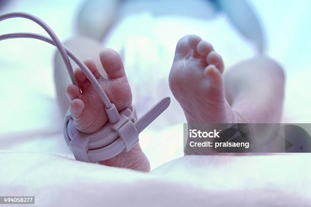 Feet Of New Born Baby Under Ultraviolet Lamp Stock Photo - Download Image Now - Baby - Human Age, Hospital, Neonatal Intensive Care Unit