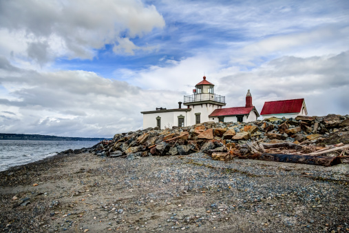 A High Dynamic Range (HDR) rendition of the West Point Lighthouse in Discovery Park, Seattle Washington.  Beautiful cloud filled sky highlights this unique lighthouse.