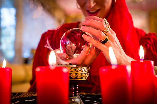 istock Soothsayer in Seance with Crystal ball and smoke 494058844