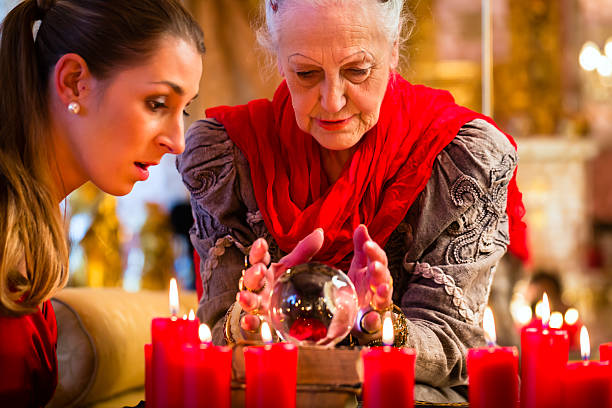 istock Soothsayer with crystal ball and client 494059284