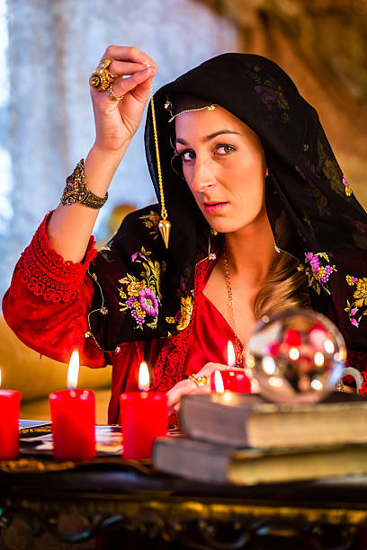 istock Radiesthesist in Seance dowsing with pendulum 494059726