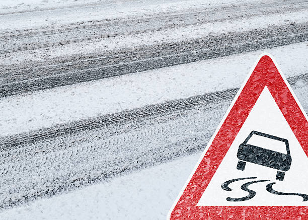 Winter Driving - Caution - Risk of Snow and Ice stock photo