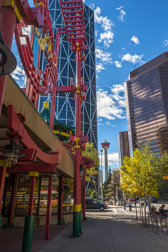 Calgary, Alberta, Canada - September 20, 2015: Entrance to the Chinatown dragon mall on the left side in Calgary downtown. Calgary downtown and Calgary Tower on the back ground.