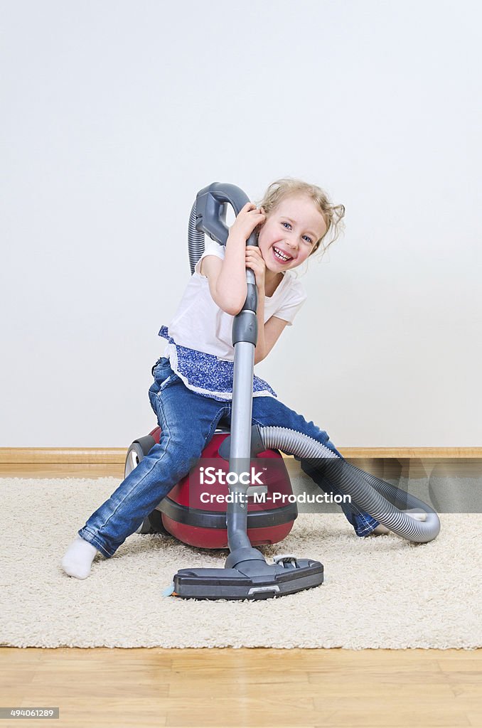 Cute little girl having fun during house cleaning. Activity Stock Photo