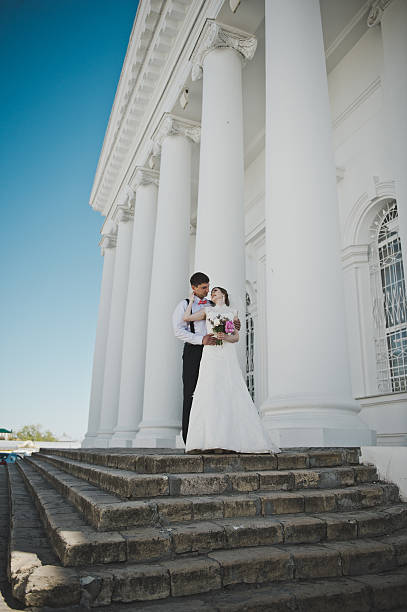 istock The bride and groom on the background of white columns 494061302