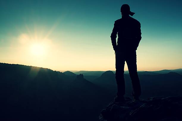 istock Hiker in long cap on rock. Beautiful miracle of nature 494063304