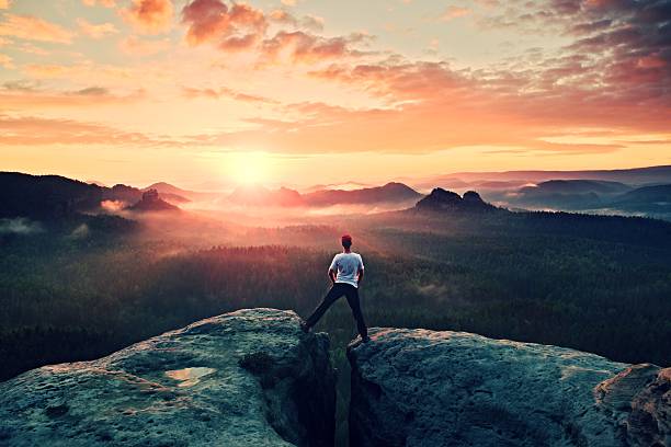 istock Crazy hiker in black jumping between two rocky peaks 494063648