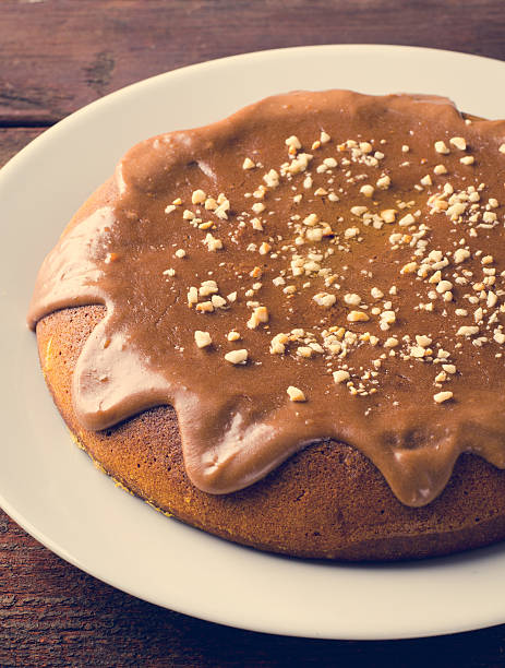 istock Pumpkin cake with caramel and peanuts on wooden table 494065370