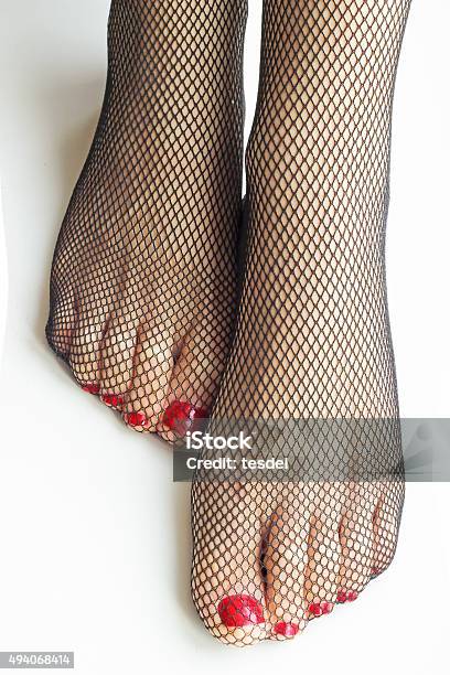 Woman Feet With Fishnet Tights Isolated On White Background Stock Photo - Download Image Now
