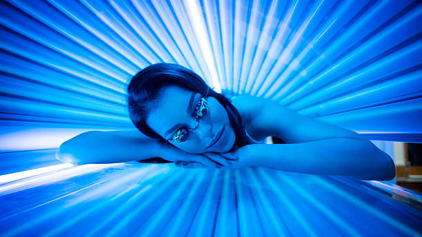 Beauty in solarium. Attractive young woman tanning in solarium and smiling. tanning bed stock pictures, royalty-free photos & images