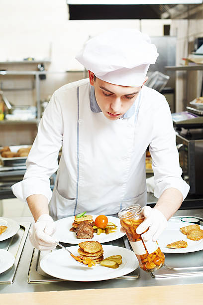 istock male cook chef decorating food on the plate 494081004