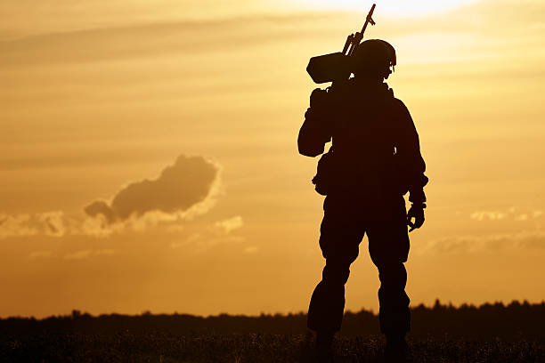 istock Military soldier silhouette with machine gun 494081154