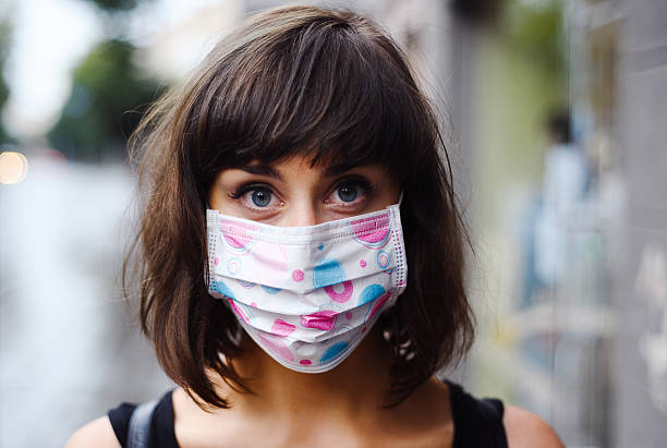 istock Young woman with respirator on the face 494081400
