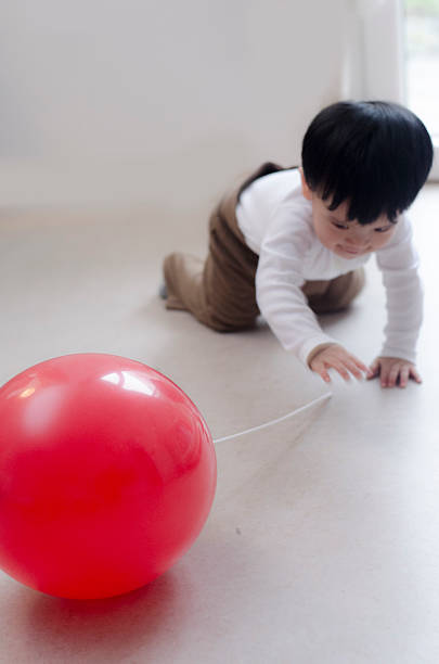 istock Asian Baby Boy playing with red balloon 494083218