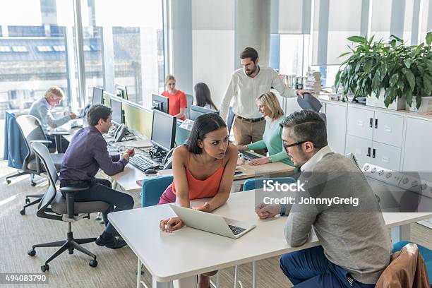 Business People Working On Laptop In Modern Office Stock Photo - Download Image Now - Office, Asian and Indian Ethnicities, Assistance