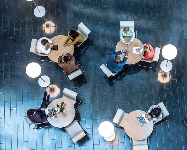Business people meeting at tables, view from above