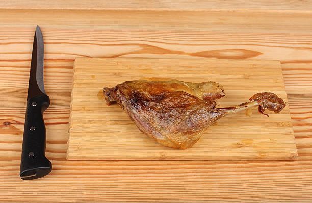 istock Roast duck on bamboo cutting board with knife 494087966