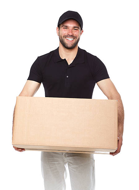 istock Smiling delivery man giving cardbox 494091135