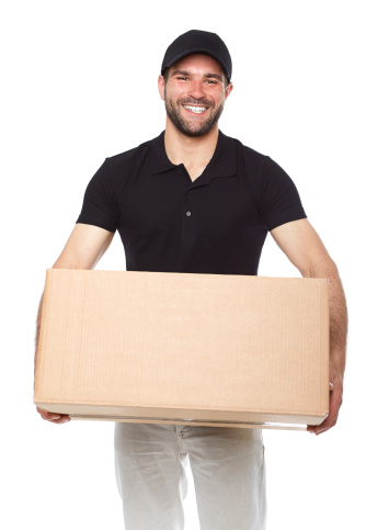 Smiling delivery man giving cardbox on white background