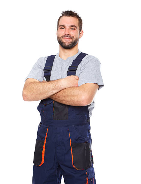 porträt eines lächelnden arbeiter in blauer uniform - handwerker stock-fotos und bilder