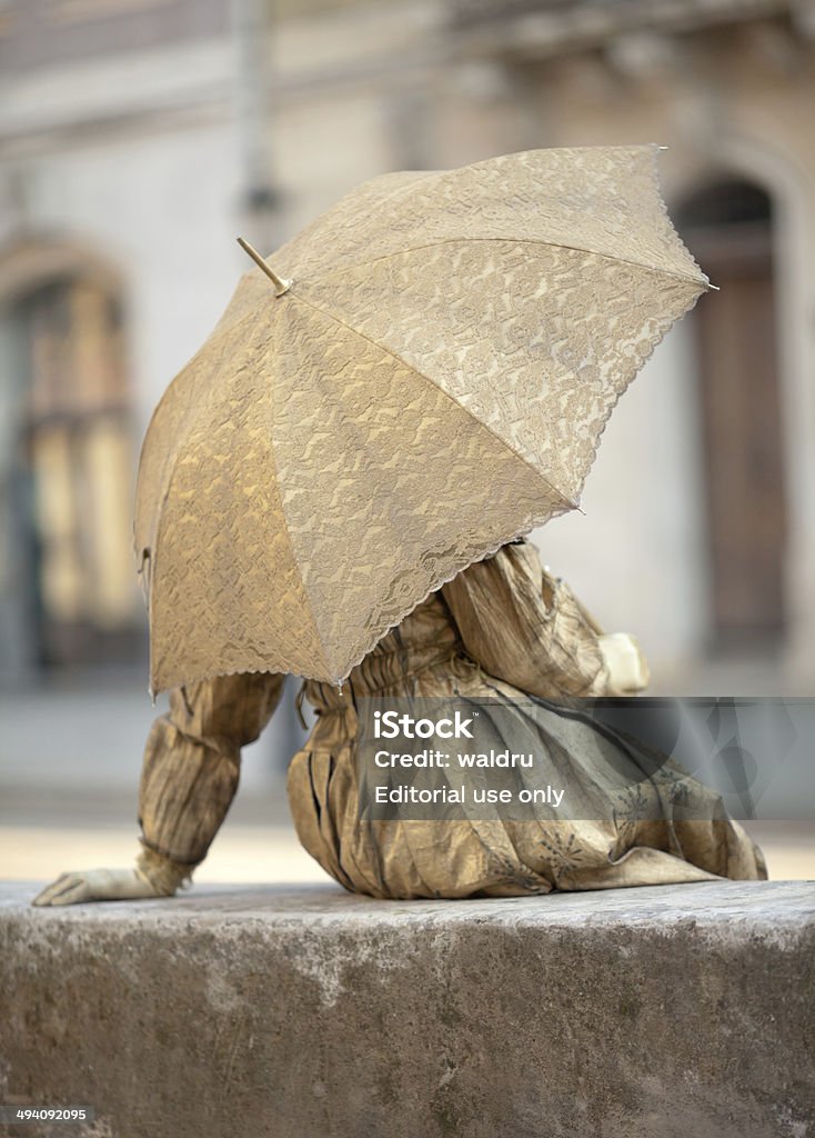 Statua sotto l'ombrello in tempo reale - Foto stock royalty-free di Abbigliamento