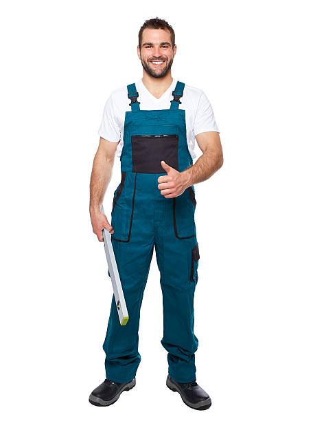 istock Smiling worker in green uniform with spirit level 494092393