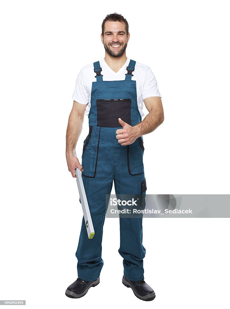 Smiling worker in green uniform with spirit level Smiling worker in green uniform with spirit level isolated on white background Blue-collar Worker Stock Photo