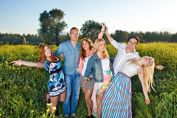 istock Group of happy young people posing in rapeseed. 494093789