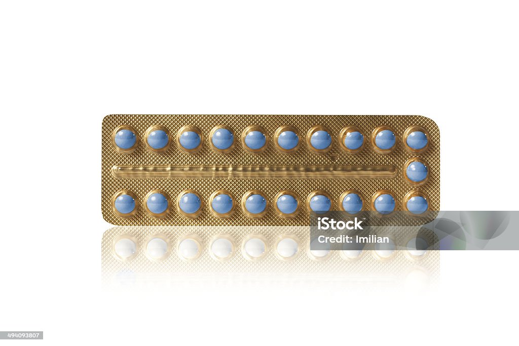 blue pills in a blister small blue pills in a golden blister Authority Stock Photo