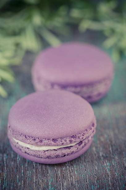 istock Lavender macaroons with cream on a wooden table. 494094011