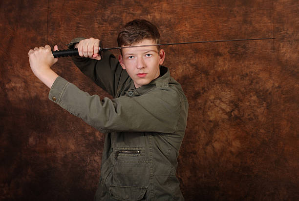 istock Man with katana sword on brown batik  background 494094212