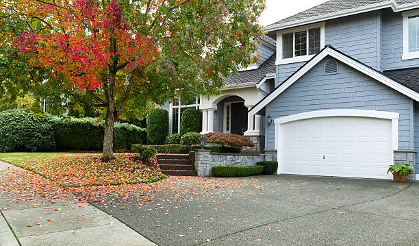 Early autumn with modern residential single family home Driveway to front walkway view of partial front of residential home during early autumn season. pacific northwest photos stock pictures, royalty-free photos & images