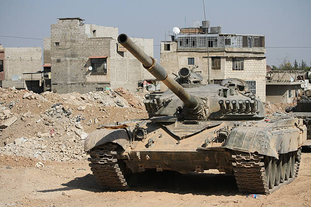 Tank Syrian national army near the combat zone in Damascus Damascus, Syria - September 14, 2013: Tank Syrian national army is close to a war zone in the city of Damascus. gunman photos stock pictures, royalty-free photos & images