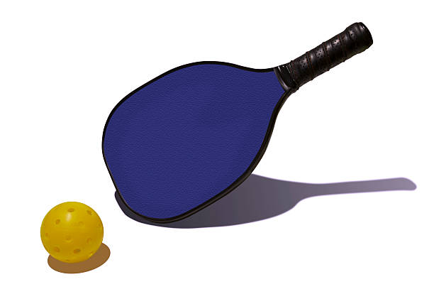 Pickleball - Yellow Ball Blue Paddle Simple, colorful composition of a blue pickleball paddle with a yellow pickleball. table tennis bat stock pictures, royalty-free photos & images