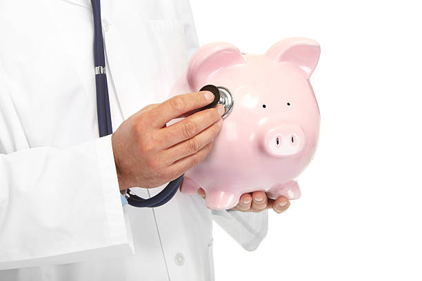 istock The doctor with pig bank 494097421