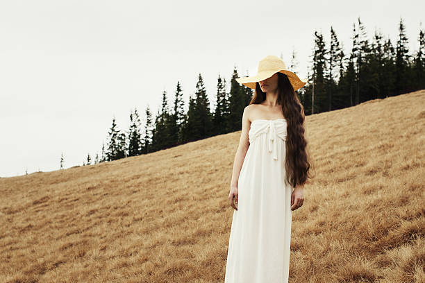 Young woman standing on a hillside in the mountains