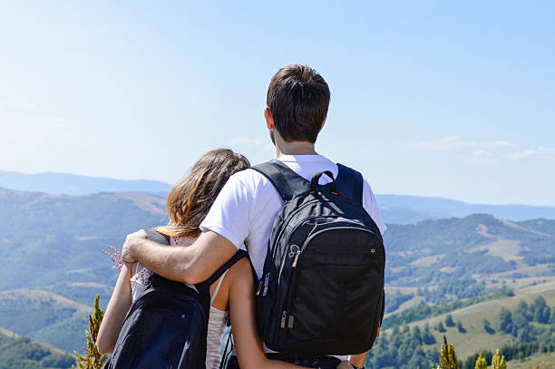 istock Couple of hikers with backpacks at viewpoint 494118950