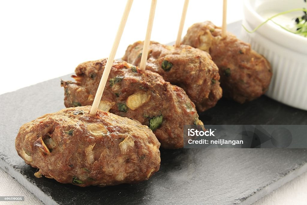mini kofte kofta shish kebabs canapes on slate with dip appetizer, asian, background, ball, beef, bites, buffet, canape, cucumbers, culture, dinner, food, greek, grill, grilled, healthy, holiday, hot, indian, ingredient, isolated, kebab, kebob, kofta, kofte, lamb, meal, meat, meatballs, mince, party, plate, platter, raita, reception, restaurant, salad, shish, skewer, slate, small, summer, table, tasty, traditional, turkish, tzatziki, white, yoghurt Appetizer Stock Photo