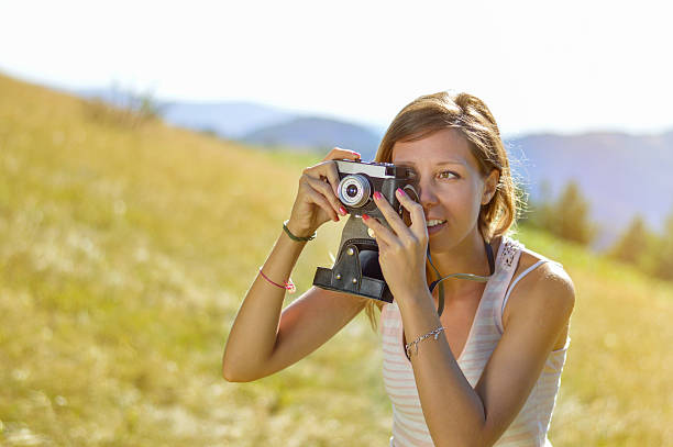 istock Young and  beautiful woman holding a retro camera 494119090