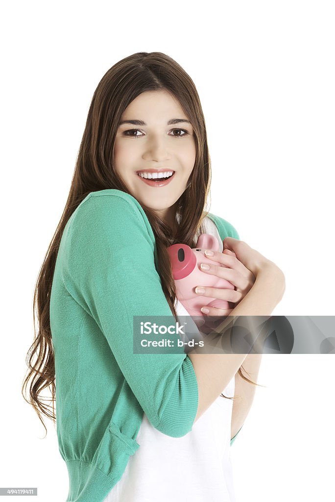 Young casual woman holding piggy-bank. Young casual woman holding piggy-bank. Isolated on white. Coin Stock Photo